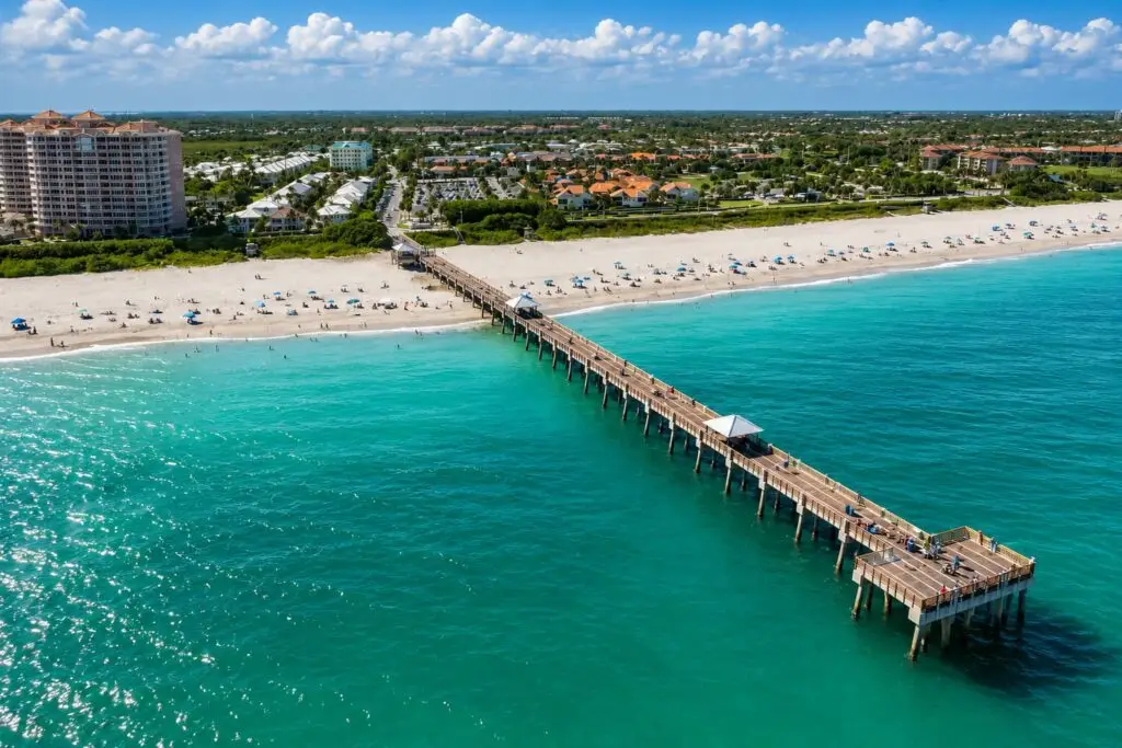 Aerial view of the Juno Beach pier extending into turquoise ocean water